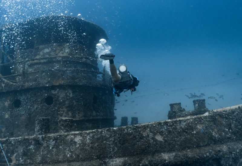 Scuba diver exploring a historic shipwreck